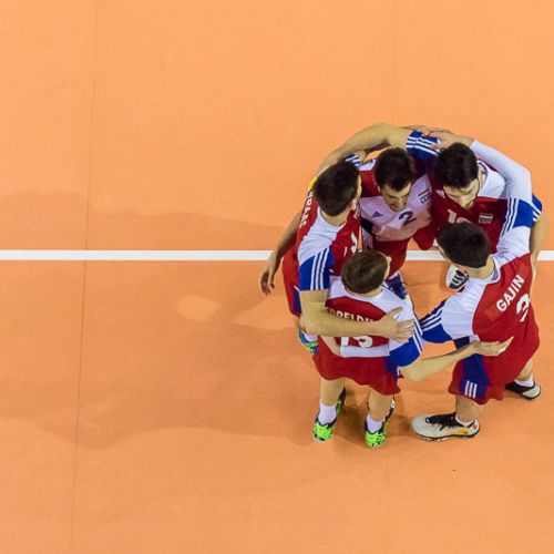 volleyball players come together